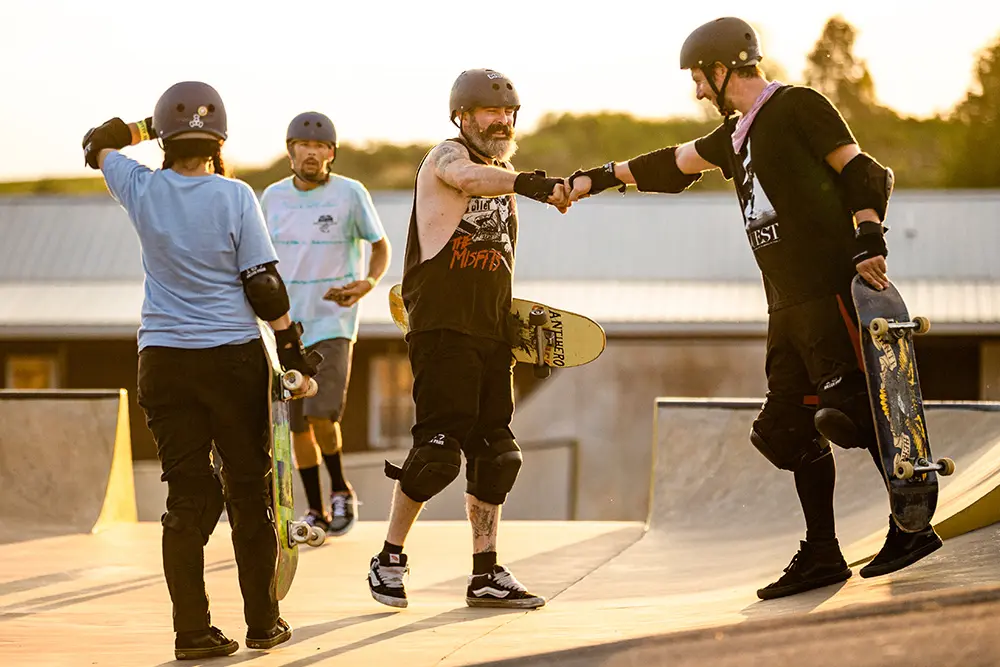 Adult Camp skaters giving knucks